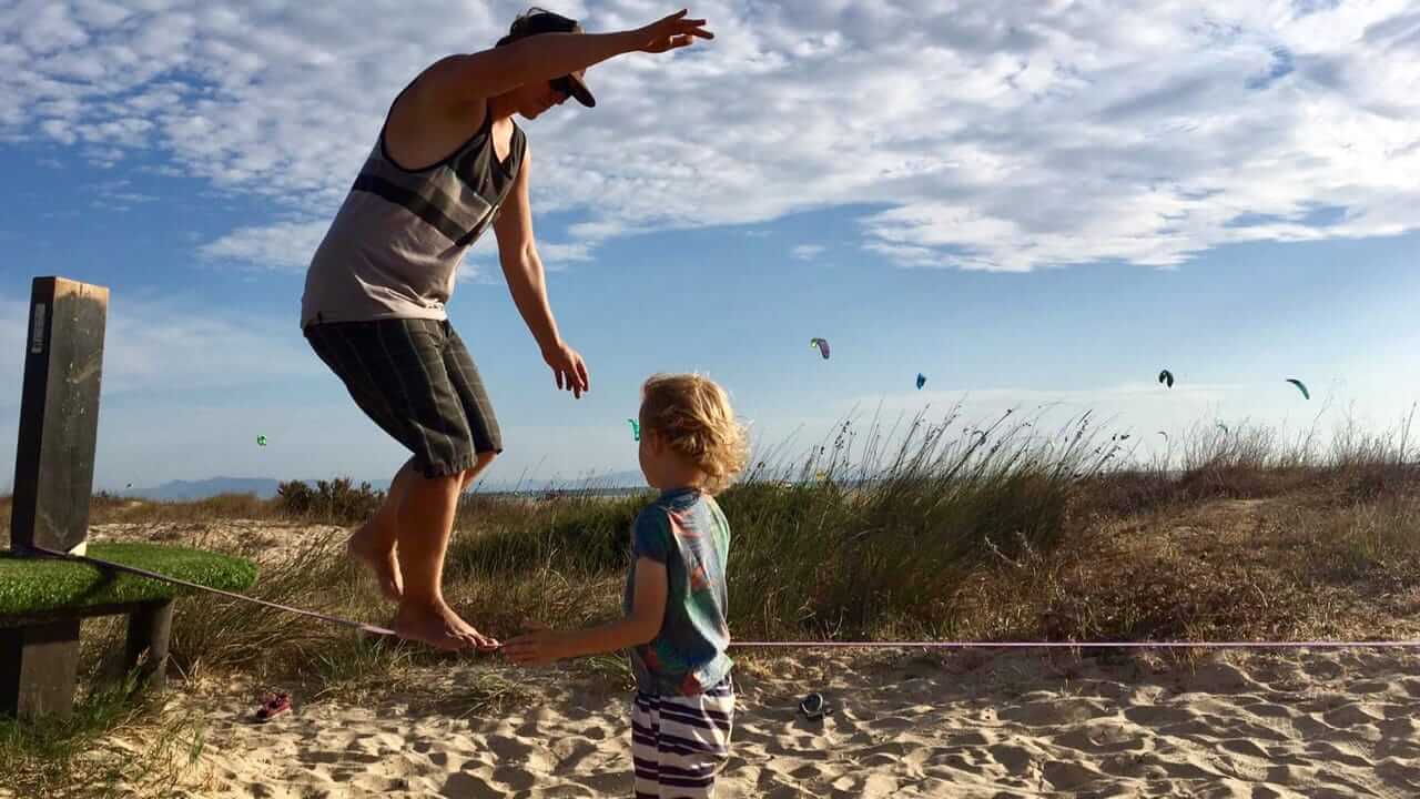 Juegos para los que se quedan en casa y los campistas de jardín 21 Familias con niños disfrutan jugando al slackline en movimiento Foto Henrike Michel